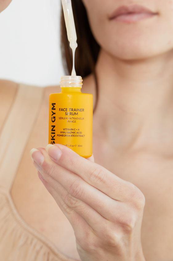 Woman Using Skin Gym's Face Trainer Serum